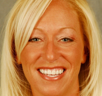 The image shows a woman with blonde hair, smiling at the camera.