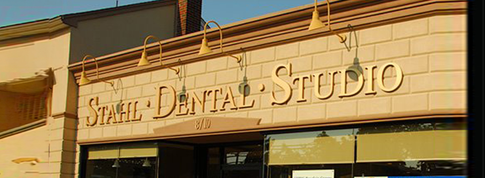 The image shows a storefront with a sign that reads  Stahl Dental Studio.