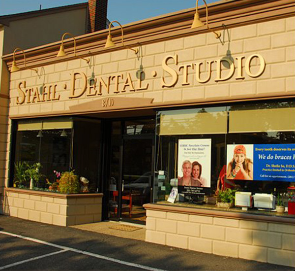 The image shows a storefront with the sign  Stahl Dental Studio  prominently displayed above a window.