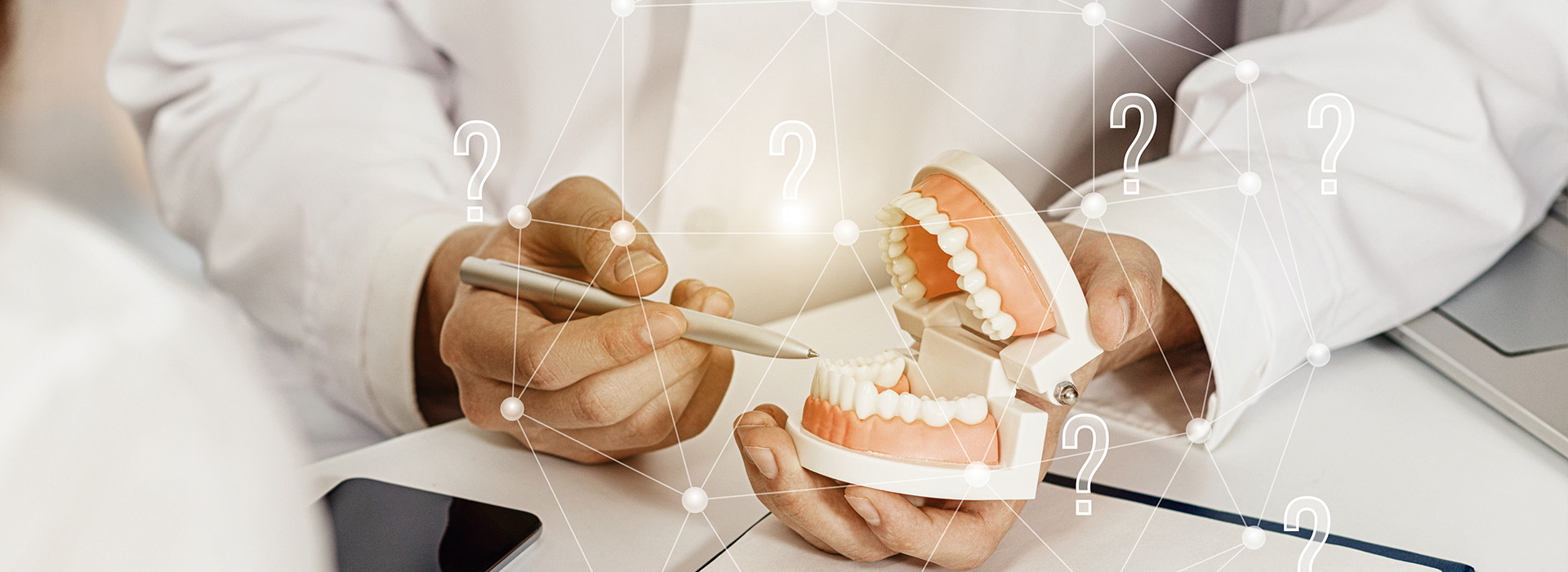 A person holding dental implants in their hand, with a focus on the technology and precision involved in dental care.