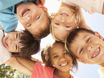 A group of children posing for a photo with smiles on their faces.